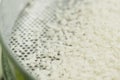 Sifting rice grains through sieve Royalty Free Stock Photo