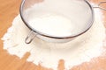 Sifting wheat flour through sieve