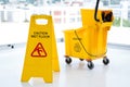 Sigh board with mop bucket in room Royalty Free Stock Photo