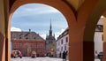 The Clock Tower in Sighisoara, seen through the arches at the entrance into the Citadel Square on a sunny day. Royalty Free Stock Photo