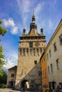 Sighisoara - The famous Sighisoara Clock Tower with people passing by