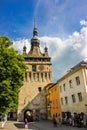 Sighisoara - The famous Sighisoara Clock Tower with people passing by