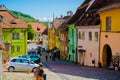 Sighisoara, Romania, May 13, 2019: Beautiful colorful street in Sighisoara in typical traditional style. Old houses are preserved Royalty Free Stock Photo