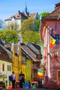 Sighisoara, Romania, May 13, 2019: Beautiful colorful street in Sighisoara in typical traditional style. Old houses are preserved Royalty Free Stock Photo