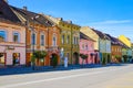 Sighisoara, Romania, May 11, 2019: Stone paved old street and cafe bar with colorful retro buildings in city center, Sighisoara