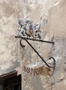 Decorative coat of arms above the entrance to the souvenir shop in Sighisoara city in Romania Royalty Free Stock Photo