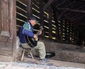 The street guitar player plays the guitar near the entrance to the tunnel, leading to the old town of Sighisoara in Romania