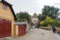 Tourists walk along the quiet streets of the old city and visit the sights in Sighisoara city in Romania Royalty Free Stock Photo