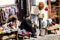 Sighnaghi, Georgia - 10 June, 2016: Elderly woman vendor selling socks, woolen slippers and bright souvenirs on the street