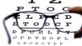 Sight test seen through eye glasses. Royalty Free Stock Photo