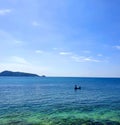 Sighted a man and his fishing boat while having dinner at a seaview restaurant. Clear blue sky