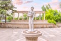Sights of Dilijan - statue of a Greek goddess with a jug and a classical antique colonnade in