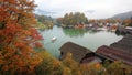 A sightseeing boat cruising on Konigssee ( King's Lake ) surrounded by colorful autumn trees and boathouses Royalty Free Stock Photo