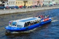Sightseeing boat goes along Fontanka River, St. Petersburg, Russia Royalty Free Stock Photo
