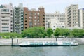 Sightseeing boat Japan river, residential apartment