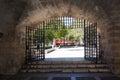 Sightseeing bus seen through stone portal