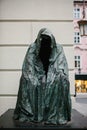 Prague, December 13, 2016: Sightseeing in Prague. Famous sculpture An empty cloak or Cloak of conscience at the entrance
