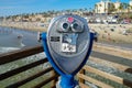 Sightseeing retro style binoculars with beach background Oceanside Pier