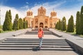 Tourism in Yerevan. Female traveler with backpack climbs the stairs leading to the entrance to Saint Gregory The