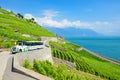 Sightseeing train with tourists driving along terraced vineyards by Geneva Lake, Switzerland. Swiss Lac Leman is popular holiday