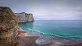 Sightseeing view to the wonderful cliffs of Etretat washed by the waves of the blue sea water, La Manche Channel. Famous Falaise d