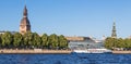 Sightseeings of Riga from the river Daugava. View of the Dome Cathedral, St. Peter`s Church and the promenade.