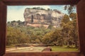 Sigiriya mountain and people walking to famous historical and archaeological site. Photo frame and UNESCO heritage area