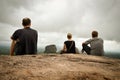 Three people sitting on Sigirya rock