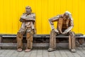 Siglufjordur, Iceland - A wooden sculpture of two old men sitting on a bench