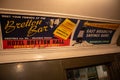 the sign above a doorway reads betiton bar with many ads on it