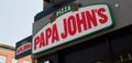 Sign above a papa johns pizza takeaway branch in brighouse west yorkshire