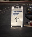 Sign advertising Contactless Curbside Pickup at retail store parking lot