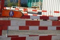 Sign for alternate route or deviation for pedestrian in detail in a complex civil engineering site marked with many ba