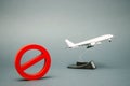 The sign of the ban and a miniature toy aircraft. Ban on flights of civil aircraft. Forbidden zone. Stop symbol. Bans on airport