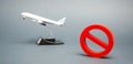 The sign of the ban and a miniature toy aircraft. Ban on flights of civil aircraft. Forbidden zone. Stop symbol. Bans on airport Royalty Free Stock Photo