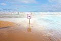 Sign on the beach: swimming is prohibited. the beach is closed. crossed out man. Coast at the resort. Royalty Free Stock Photo