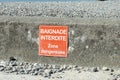 Sign on a beach with written on it `Bathing prohibited, dangerous zone`