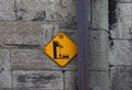 The sign - `beware of falling icicles!` - warns that ice or snow may fall from the roof of the house Royalty Free Stock Photo