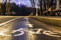 Sign bicycle path. At night in the park. this way to your health. Headlights shine towards. Headlights shine towards. Sports lifes