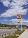 Greece, June 2020:  Sign of a biker bar in Greece on the autobahn with the image of a girl with a suitcase in the cowboy style Royalty Free Stock Photo