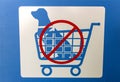 Sign in blue and white with graphic of a dog in a shopping cart indicating No Dogs Allowed In Shopping Carts Royalty Free Stock Photo