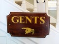 Sign board for a Gents washroom showing the direction