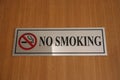 Sign board for no smoking is placed on the wooden surface. Royalty Free Stock Photo