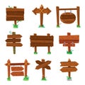 Sign boards in green grass. Wooden plank road signs, wood signboard or isolated signpost board cartoon vector set Royalty Free Stock Photo