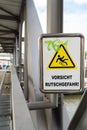 Sign on a bridge warning against slipping