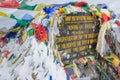 The sign with buddhist prayer flags at Thorong La mountain in Nepal