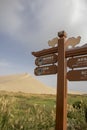 Sign for camel rides with dune and marsh, Singing Sand Mountain, Taklamakan Desert, Dunhuang, China Royalty Free Stock Photo