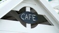 a sign on a children's play house, an inscription of a cafe, on a black board written in white chalk word-cafe