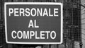 Sign with `complete personal` writing in Italian white writing on a blue background on the gate