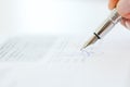 Sign a contract or agreement with a pen